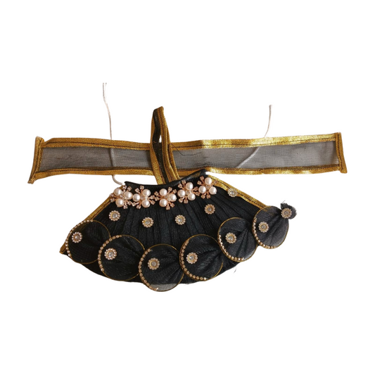 Decorative black and gold skirt with pearl embellishments on a white background
