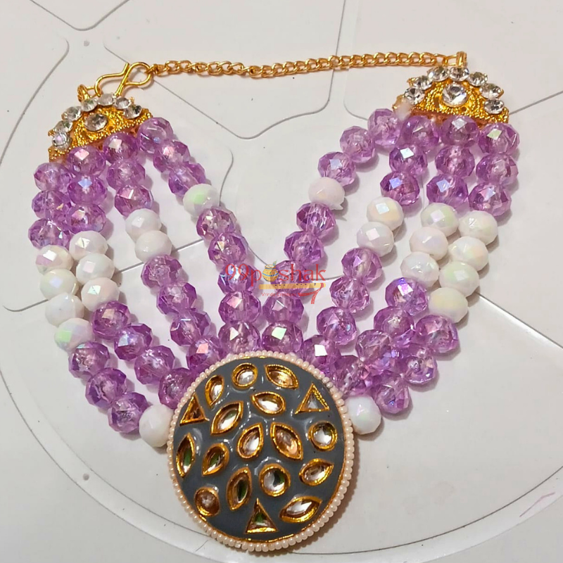 A multi-strand traditional Indian statement necklace featuring faceted light purple beads, white pearl-like beads, gold chain, and a large round gold-toned pendant with a gray-blue center.