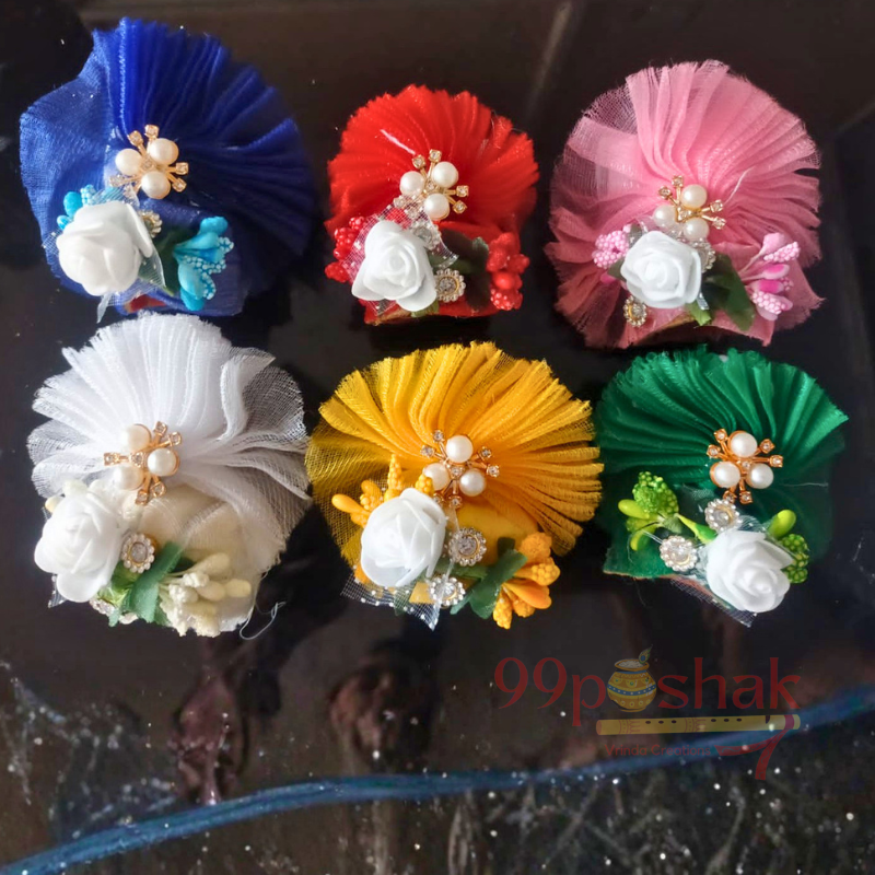 Colorful flower-shaped headbands on a reflective surface with '99poshak' branding.